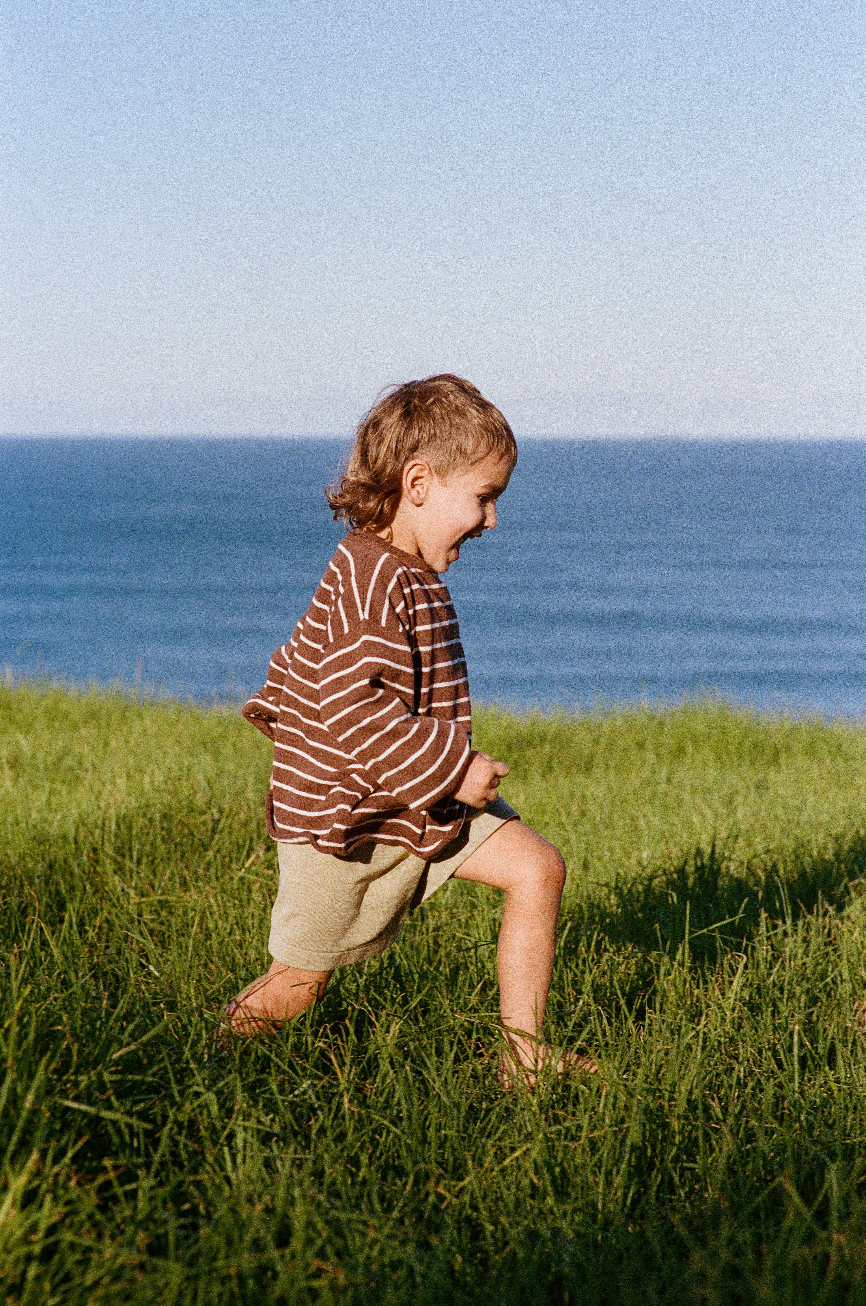 boy running outside in cotton linen knitted shorts with elasticated waist and tie