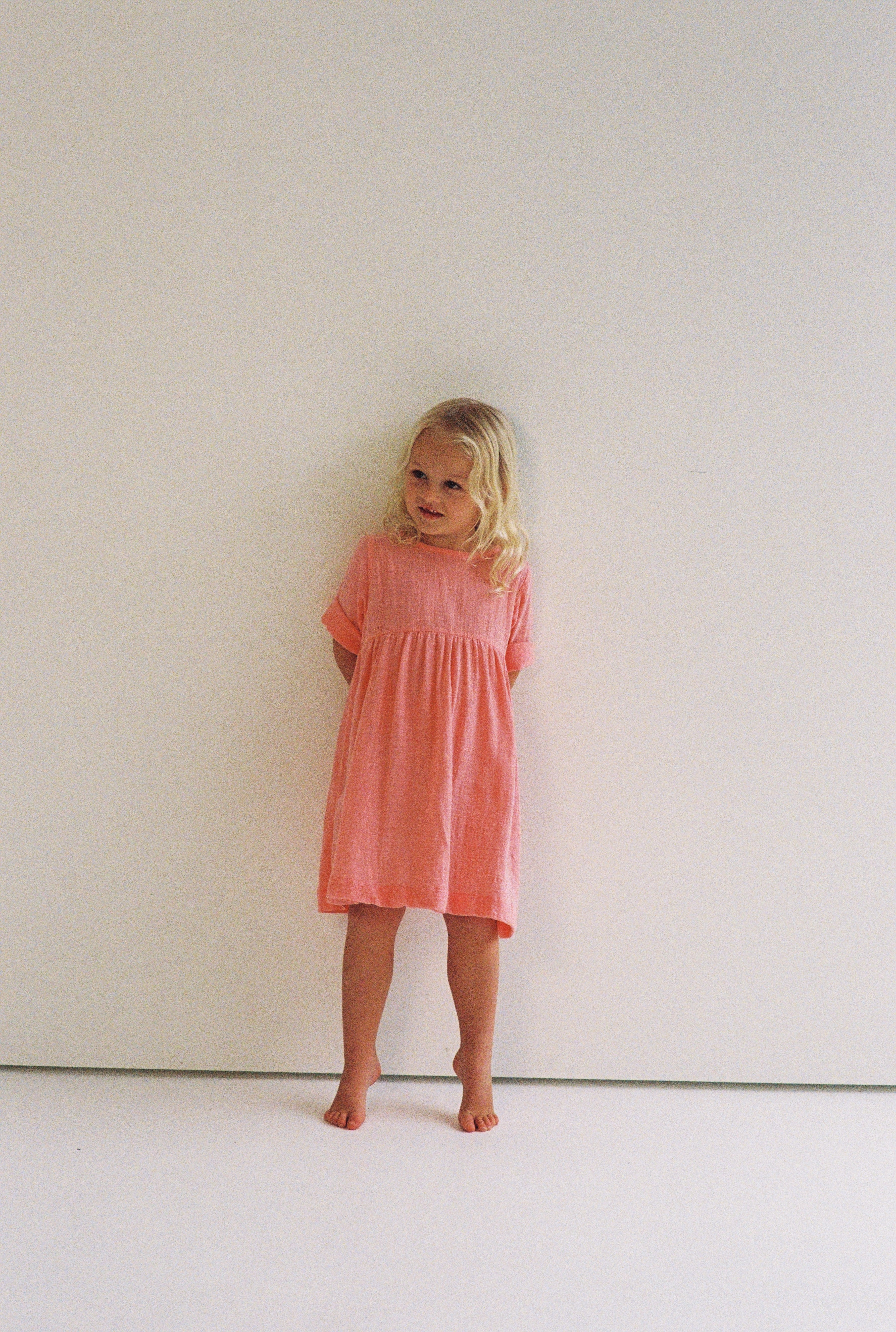 girl wearing woven cotton dress in pink by illoura the label