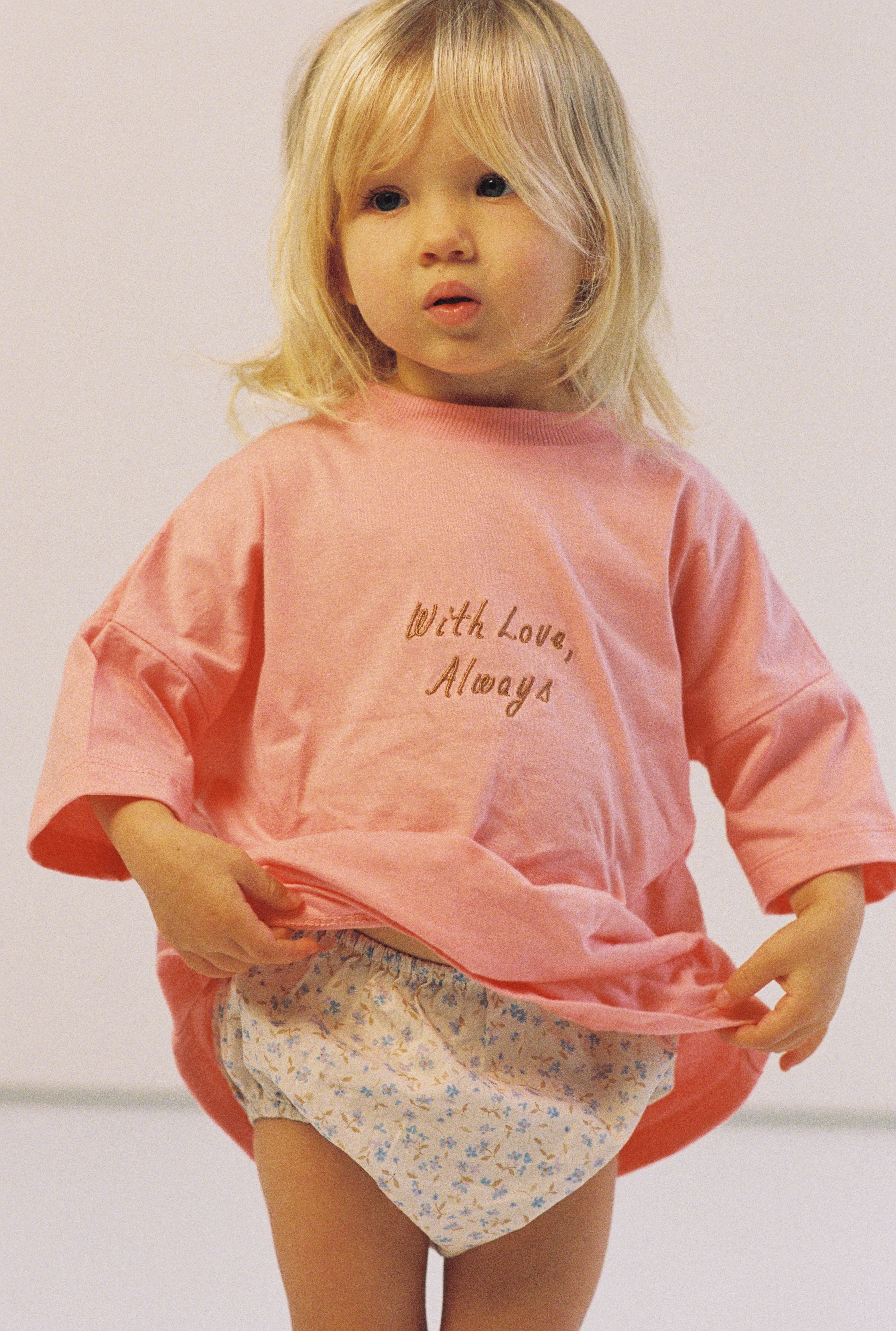 toddler girl wears oversize pink tee with chocolate embroidery and floral print bloomers