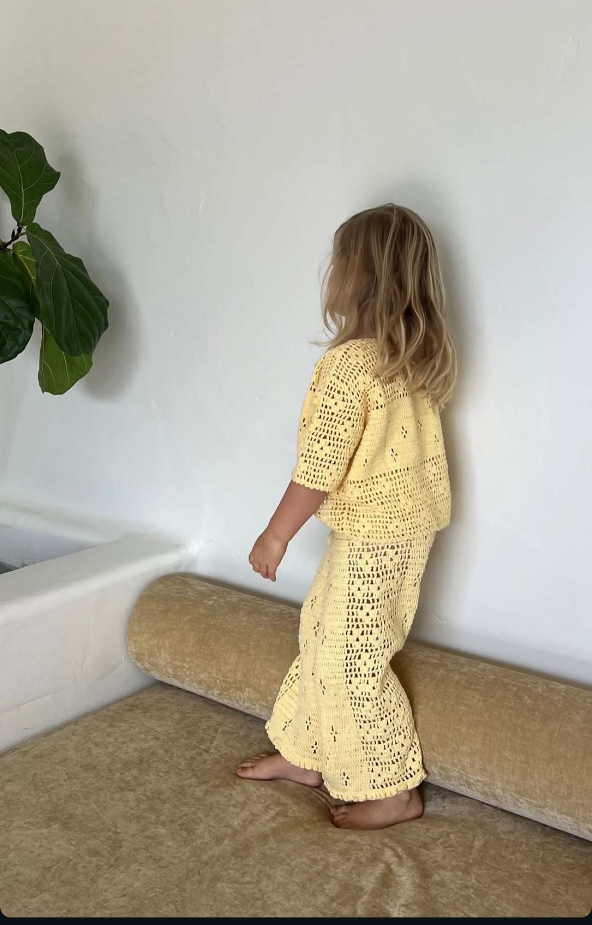 girl wearing handmade cotton crochet top and pants in butter yellow by Illoura the label