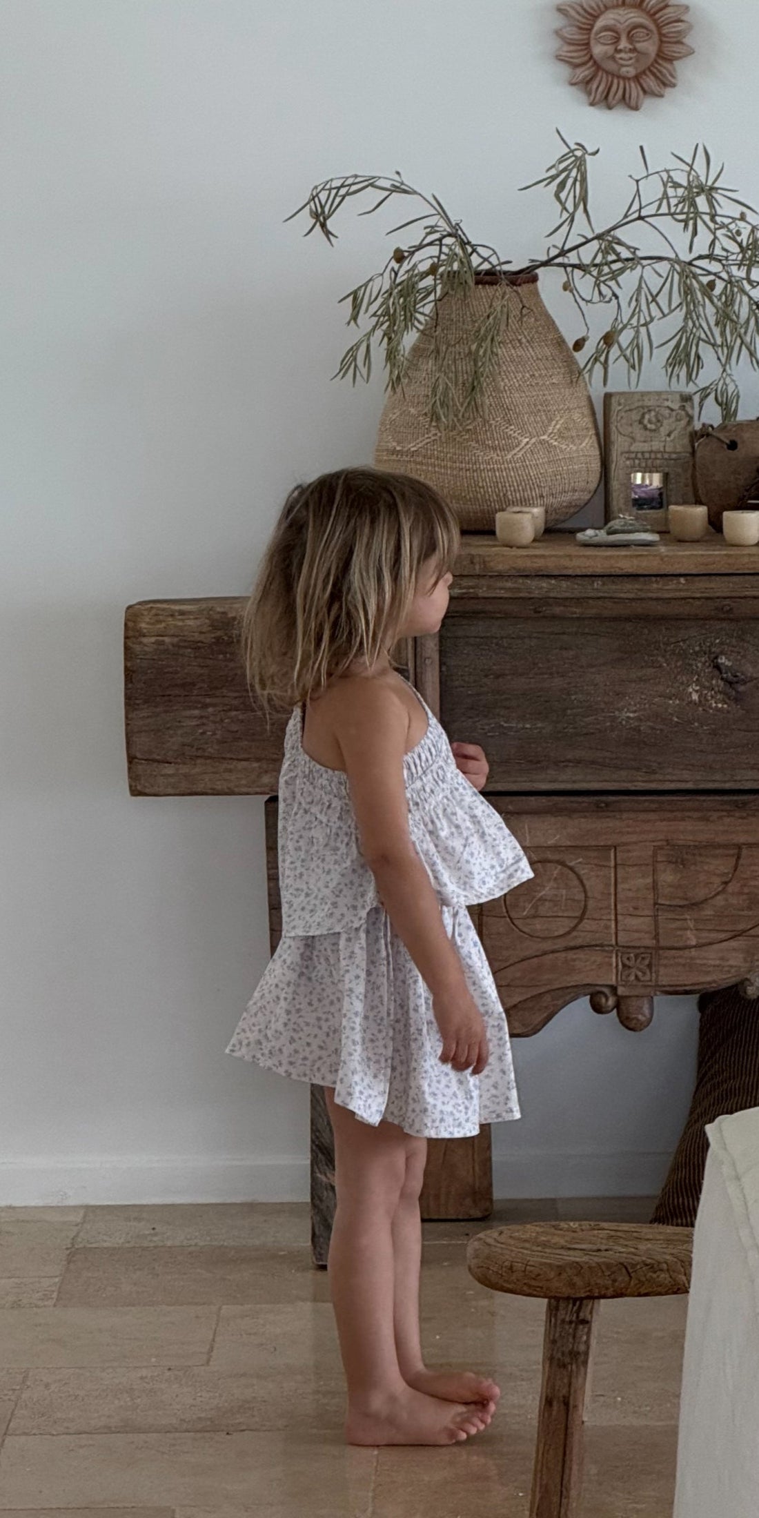 girl wearing one shoulder floral print top with gathering detail in 100% cotton poplin with floral print skirt in 100% cotton poplin