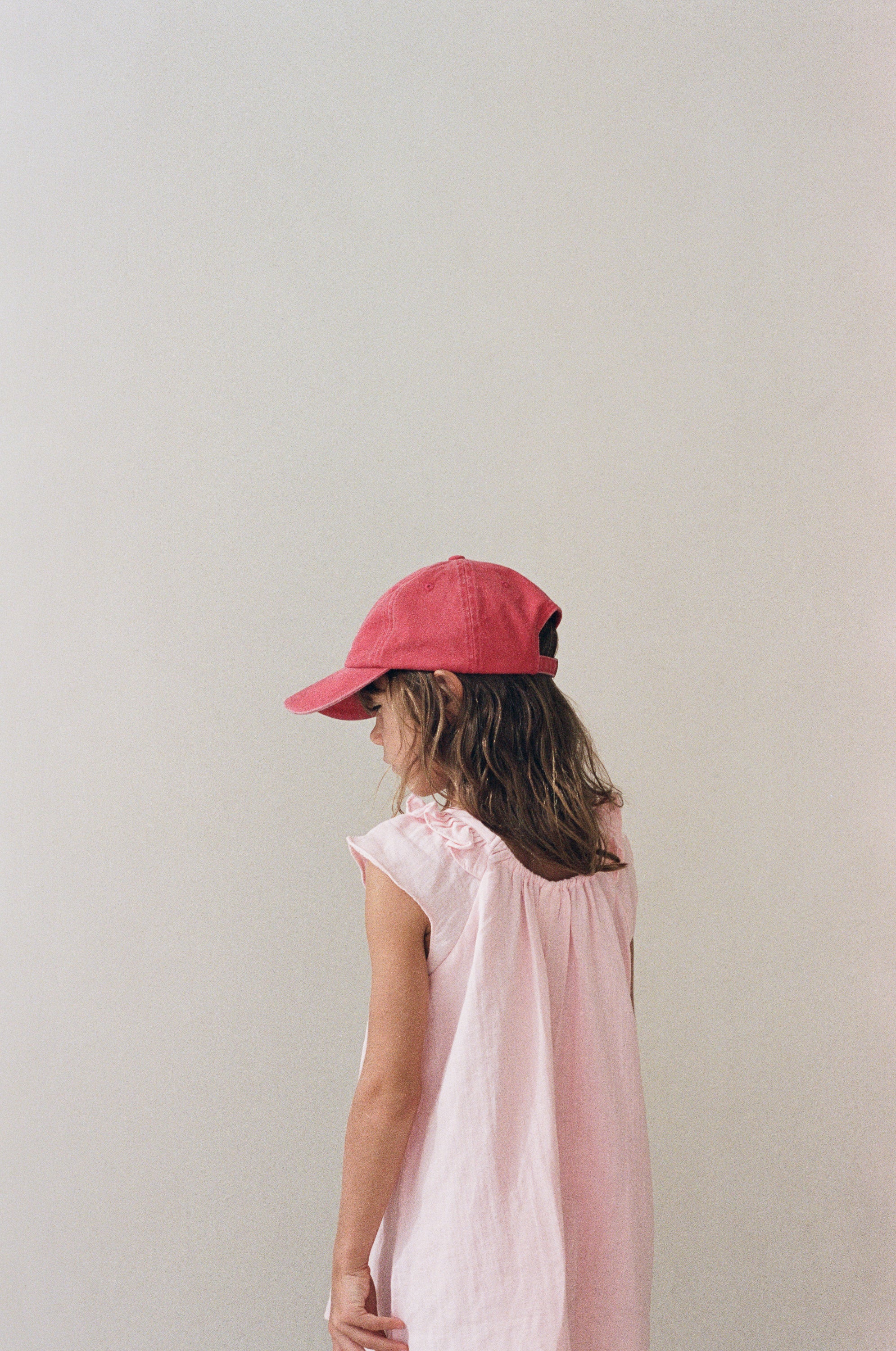 girl wearing cotton canvas cap washed red by Illoura the label