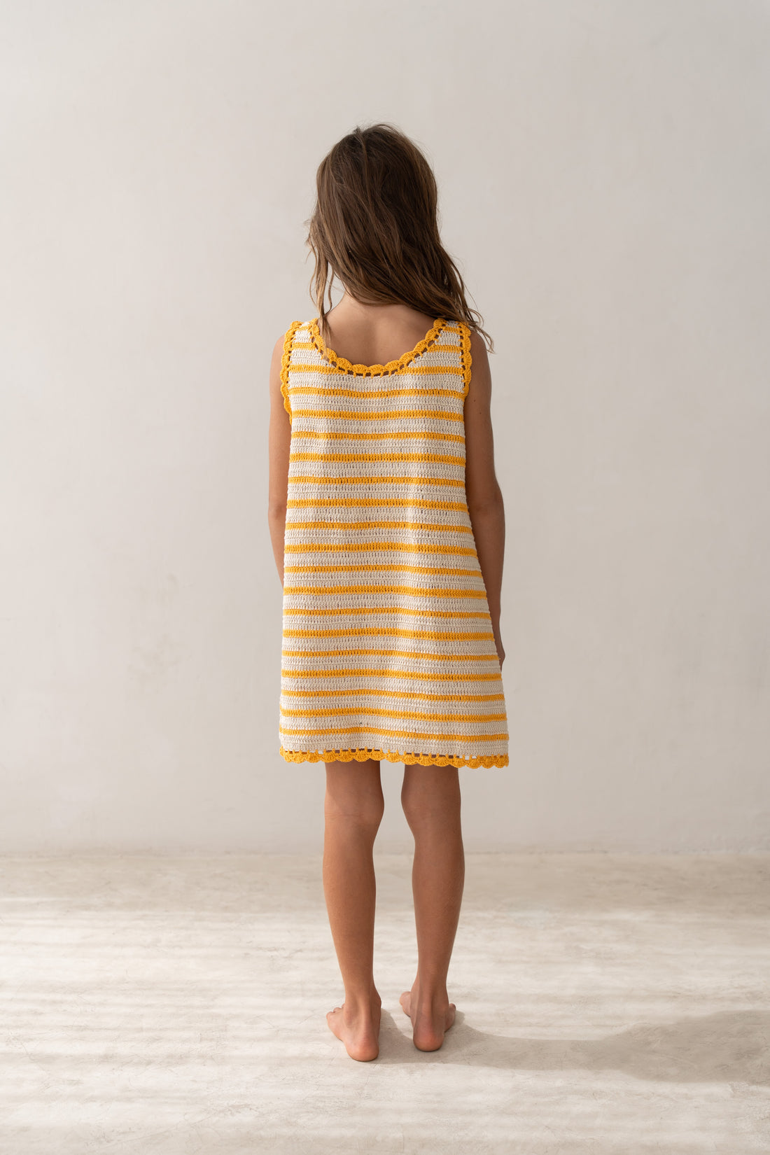 girl wearing handmade cotton crochet dress by Illoura the label