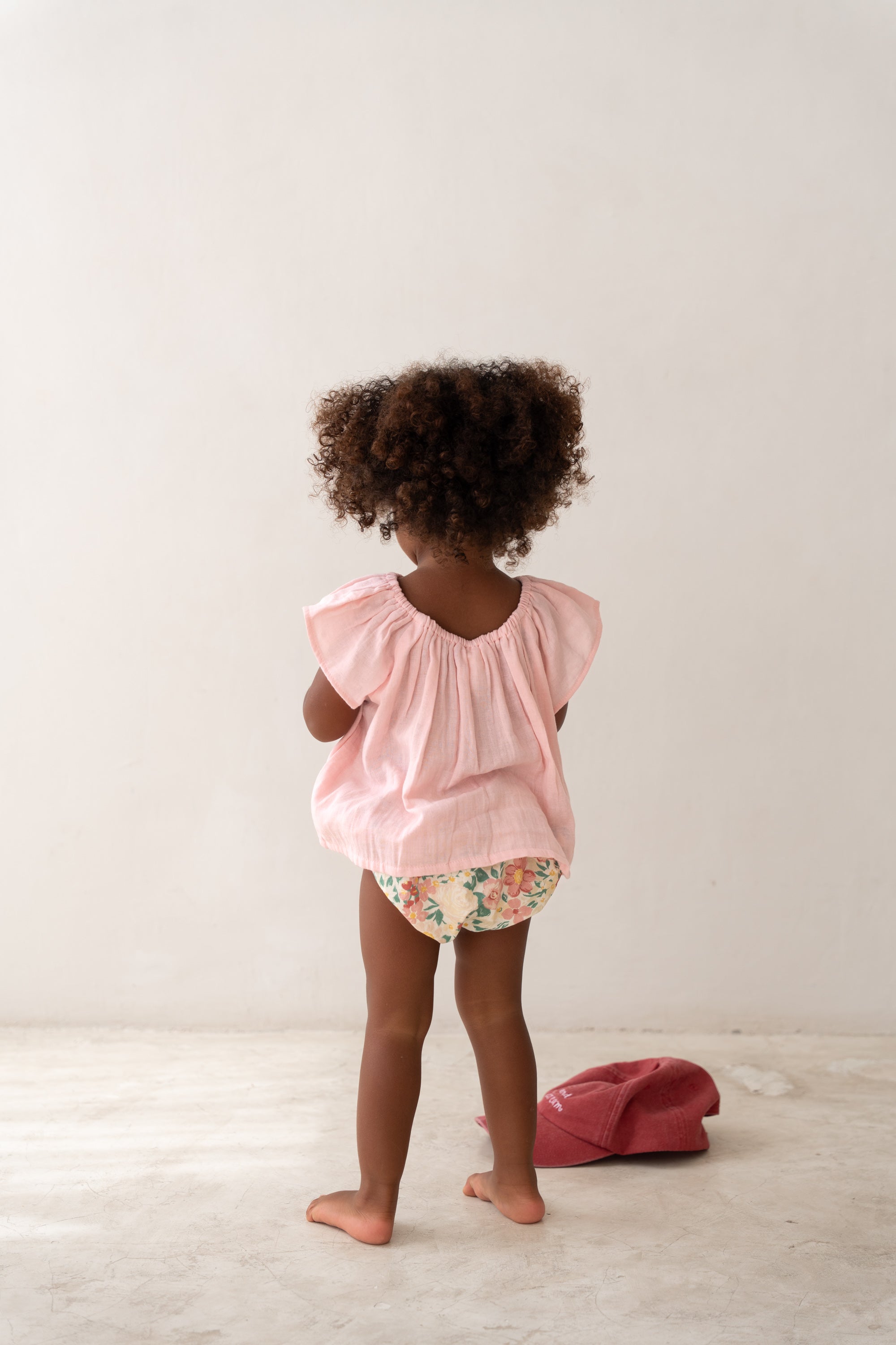 toddler girl wearing pink cotton blouse and floral bloomers by Illoura the label