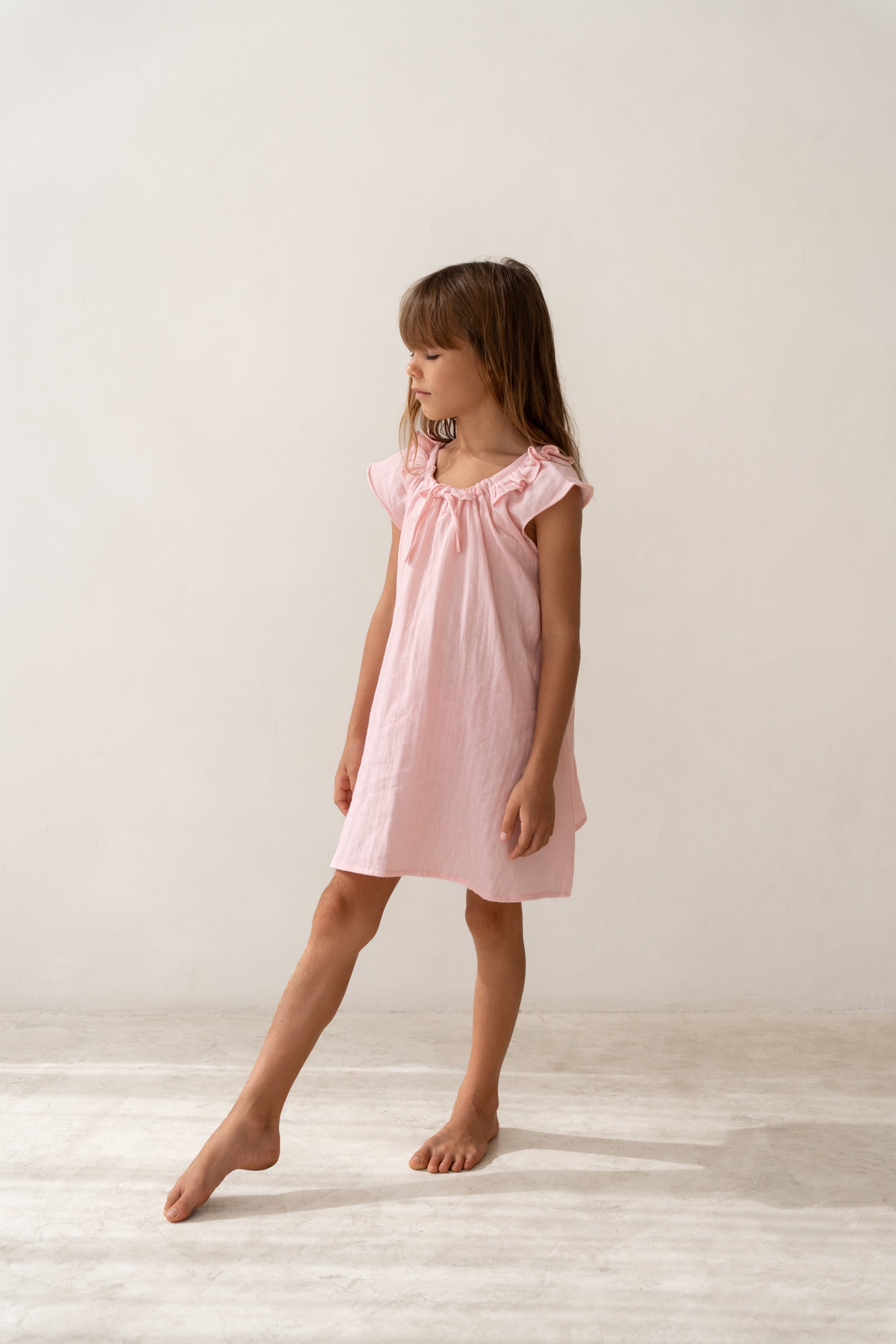 girl wearing pink cotton dress by Illoura the label