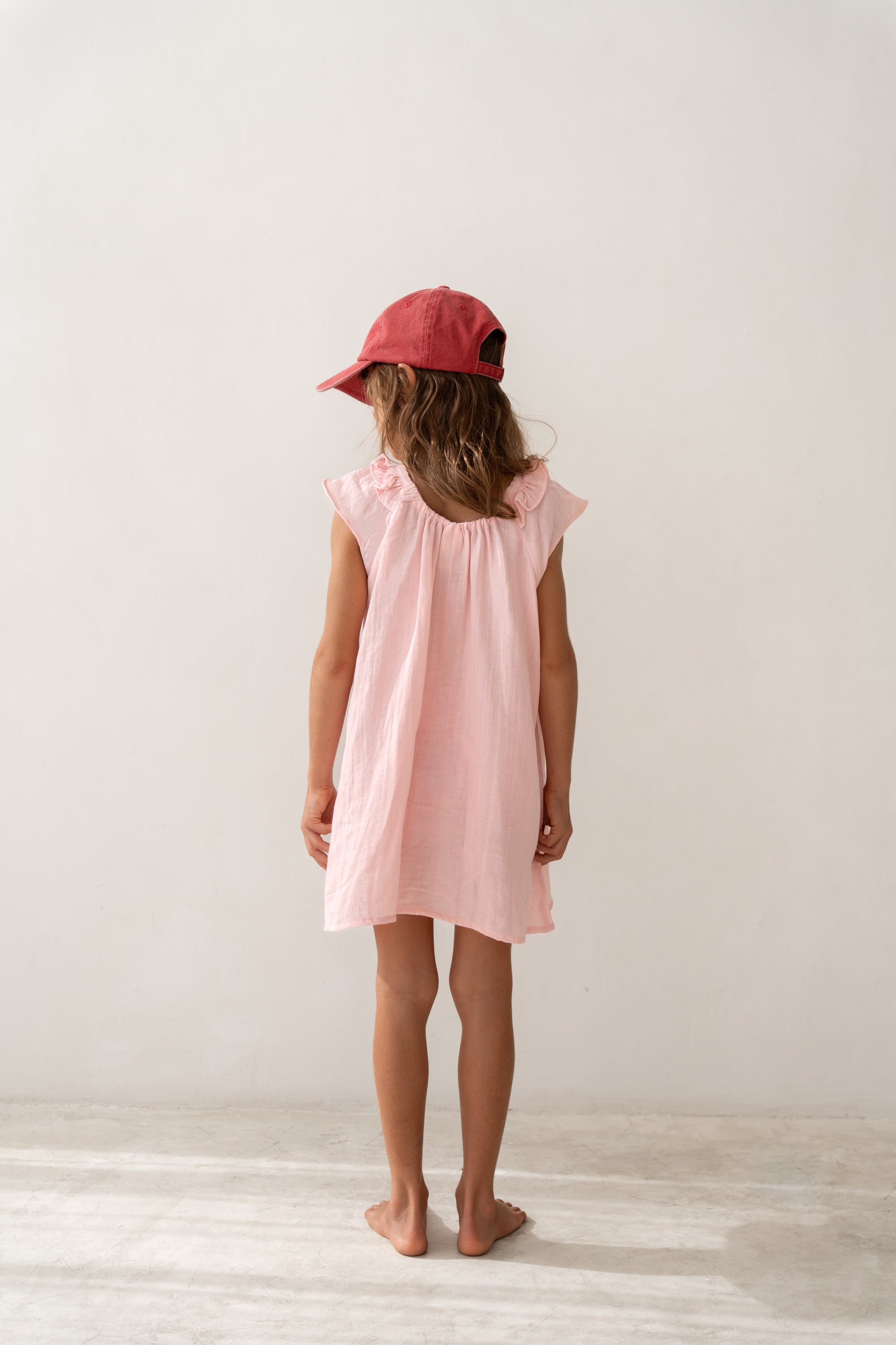 girl wearing pink cotton dress by Illoura the label