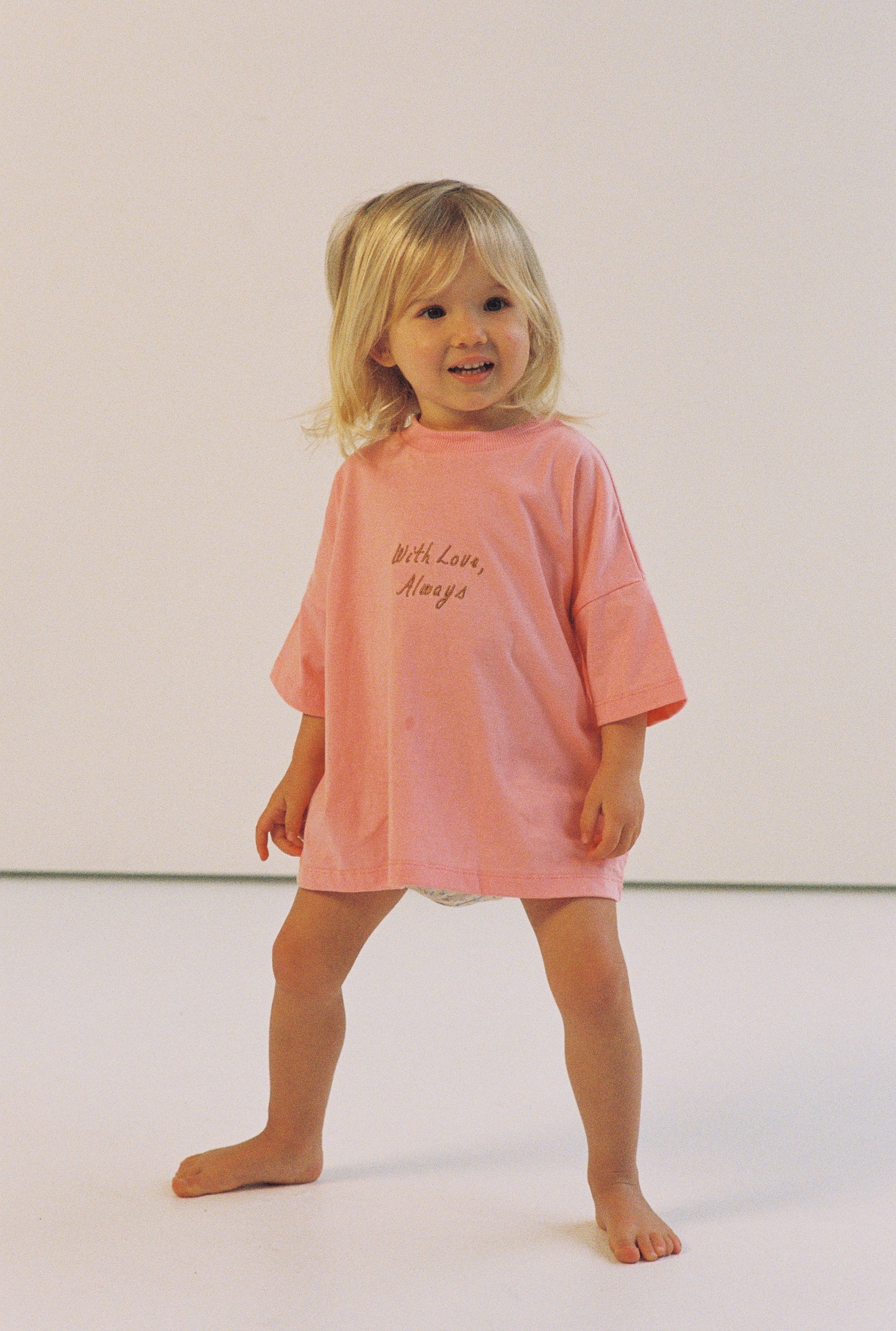 girl wearing cotton jersey t-shirt in pink with embroidery by illoura the label