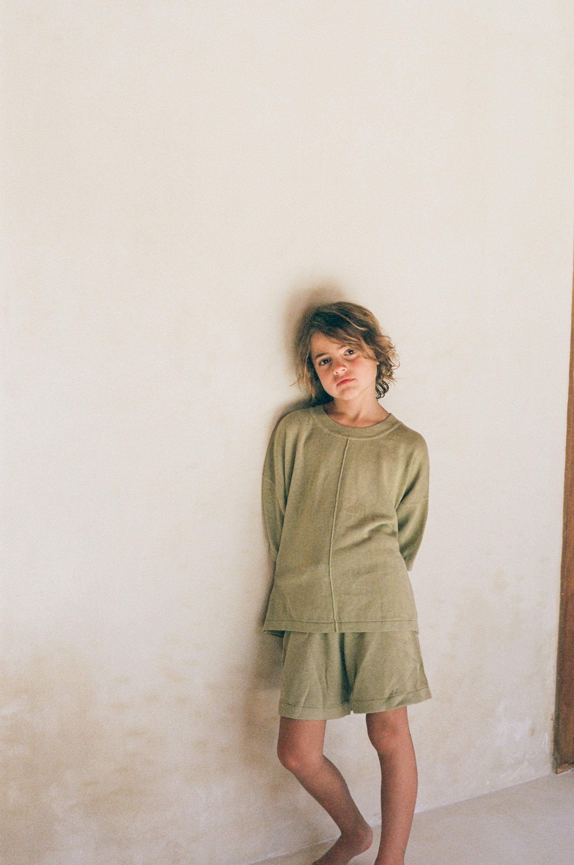 boy wearing cotton linen blend knitted t-shirt and shorts in green by illoura the label