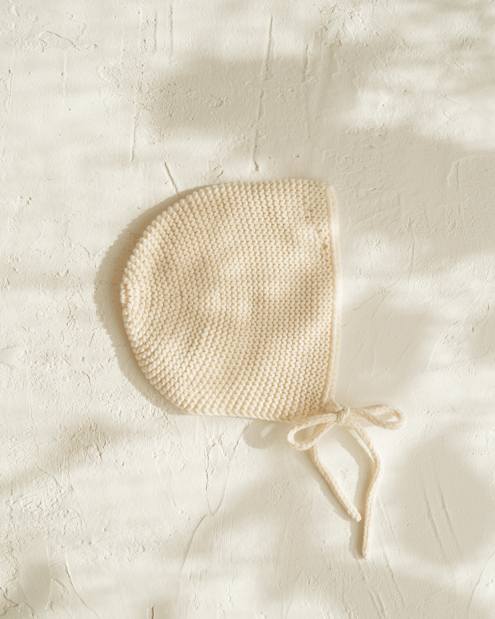knitted cotton baby bonnet. Vanilla colour