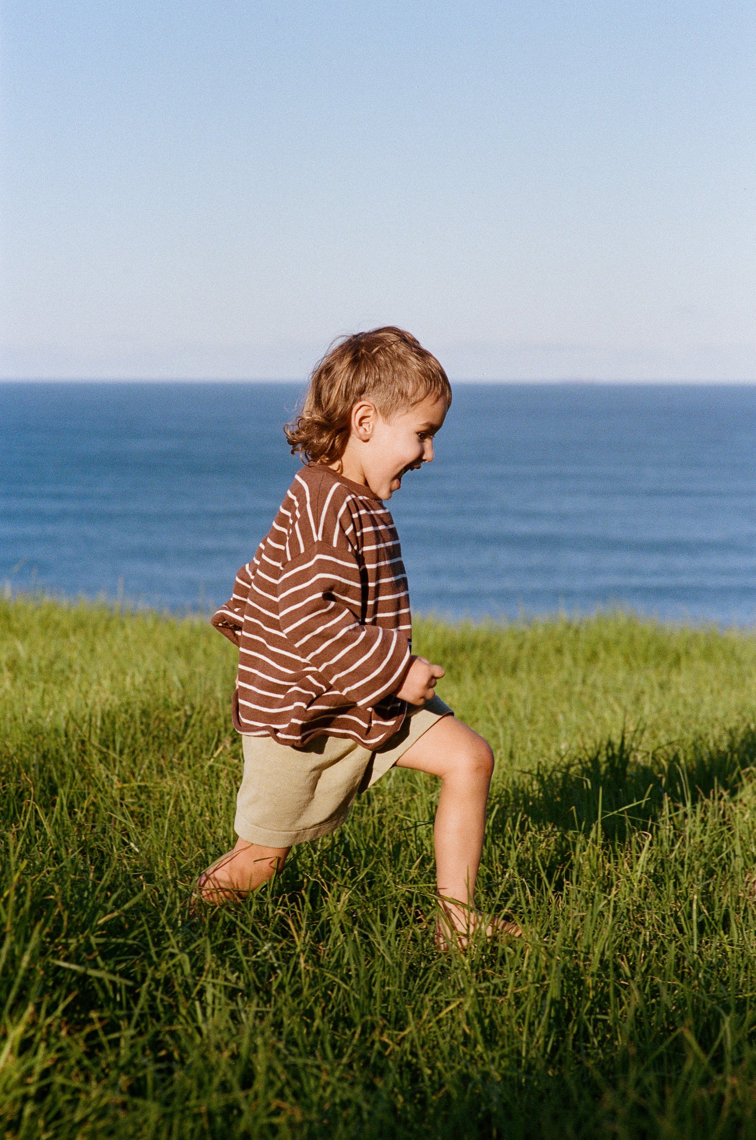 boy running outside in cotton linen knitted shorts with elasticated waist and tie