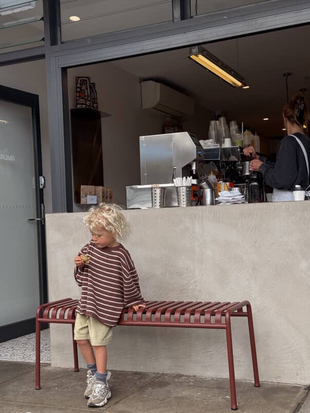 boy wearing linen cotton blend knitted jumper in chocolate with white stripe by illoura the label