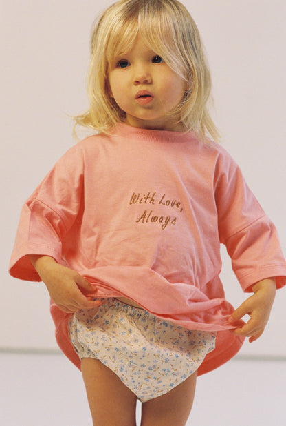 toddler girl wears oversize pink tee with chocolate embroidery and floral print bloomers
