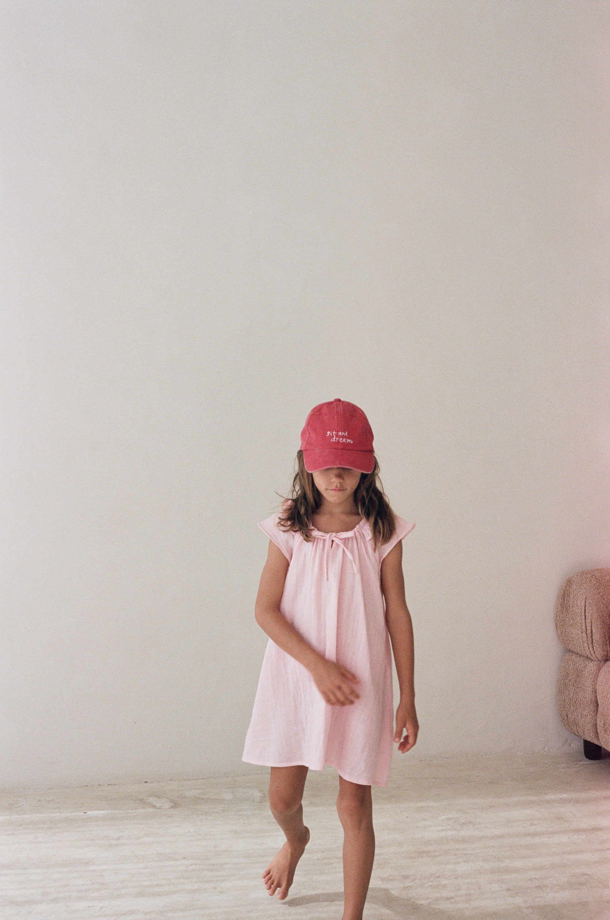 girl wearing cotton canvas cap washed red by Illoura the label