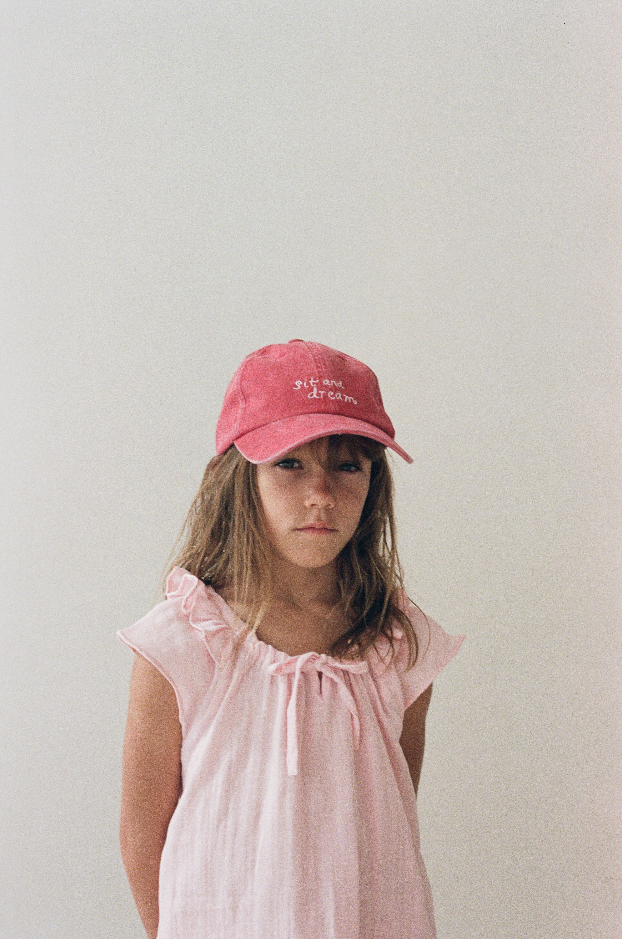 girl wearing cotton canvas cap washed red by Illoura the label