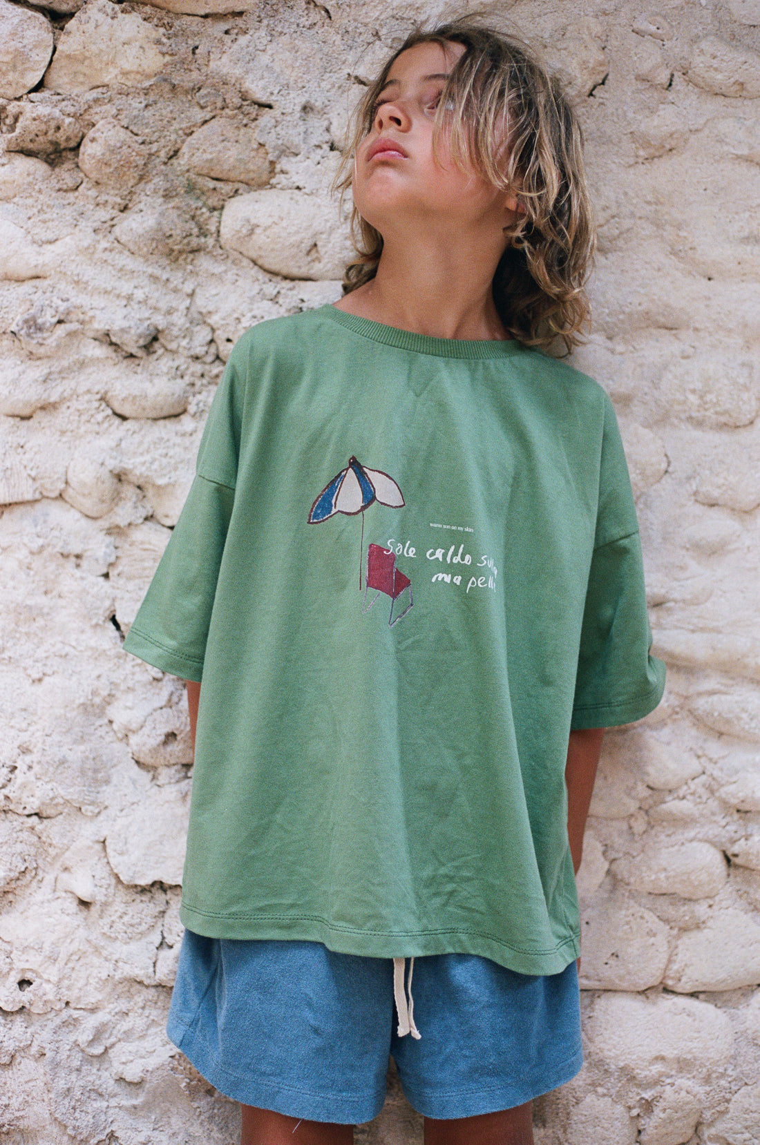 boy wearing blue cotton terry shorts and green t-shirt by Illoura the label