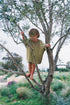 boy climbing tree wearing cotton linen blend knitted t-shirt and shorts in green by Illoura the label