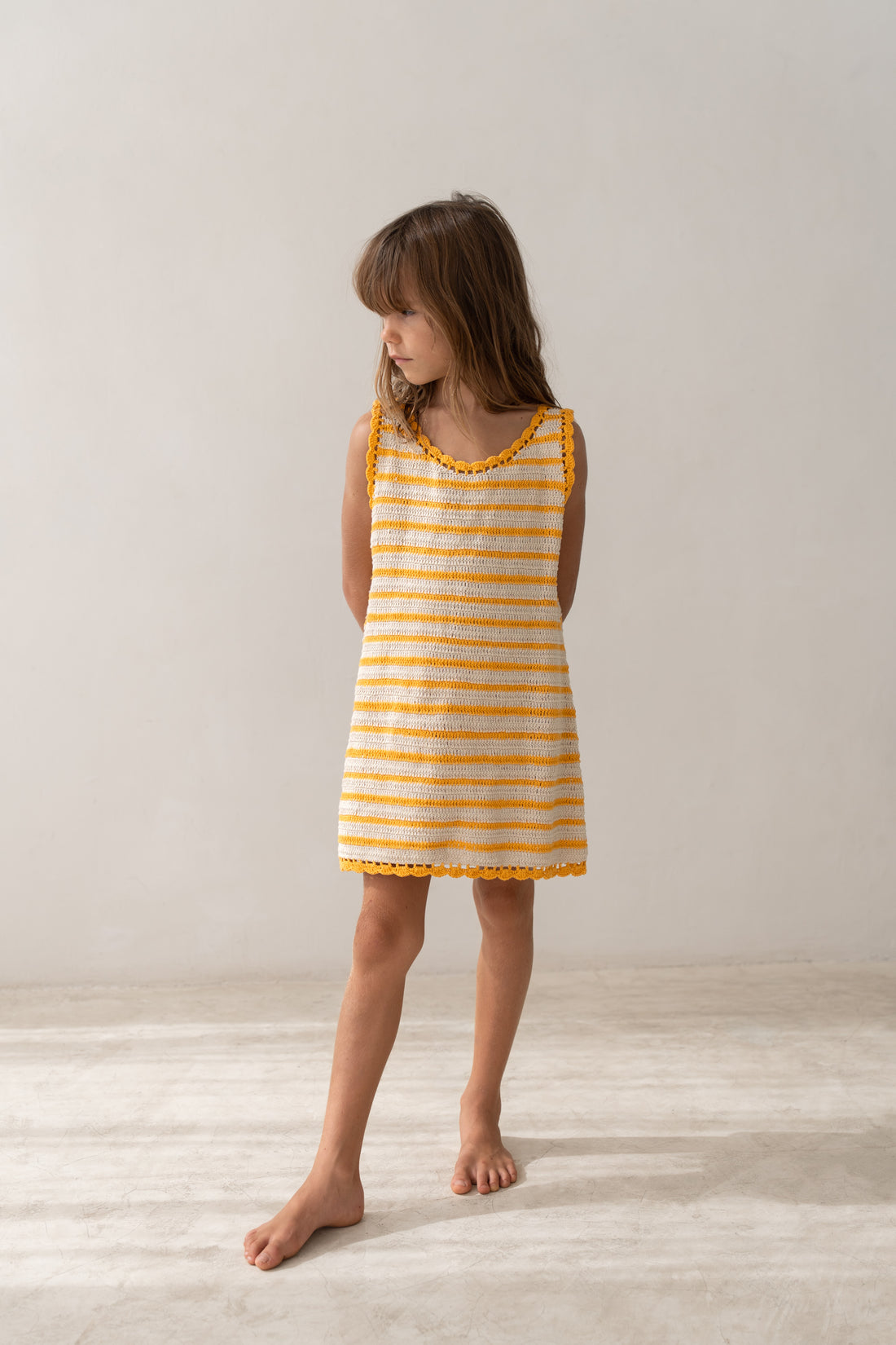 girl wearing handmade cotton crochet dress by Illoura the label