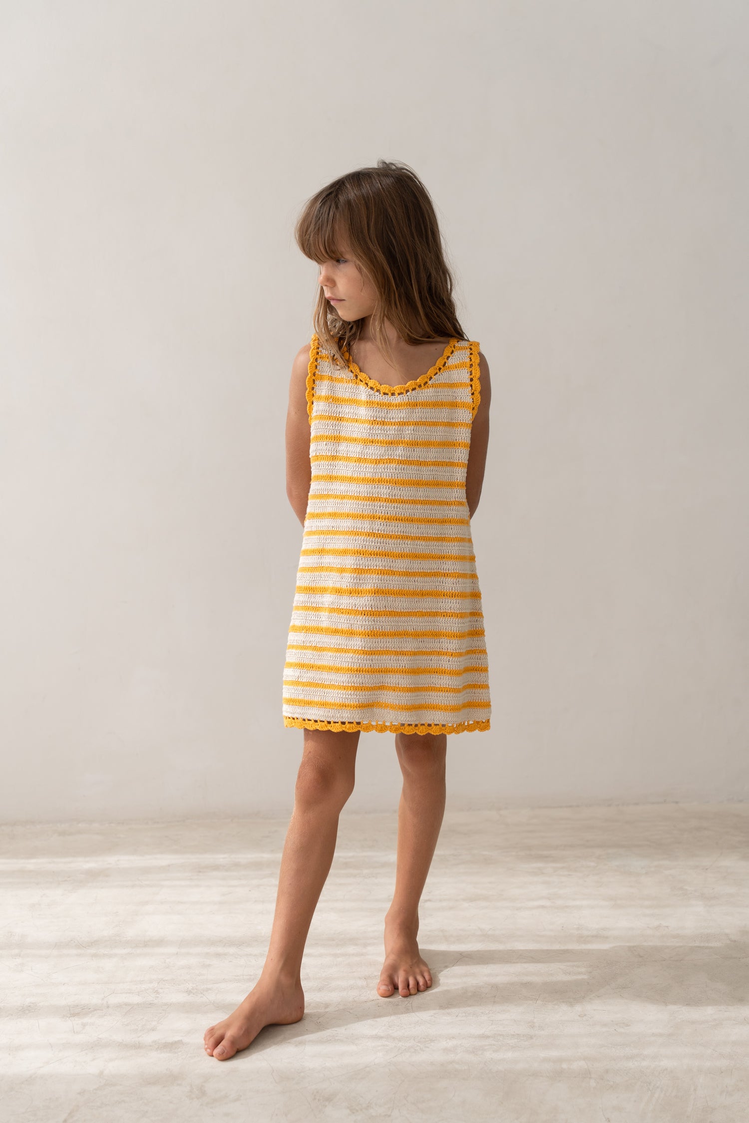girl wearing handmade cotton crochet dress by Illoura the label