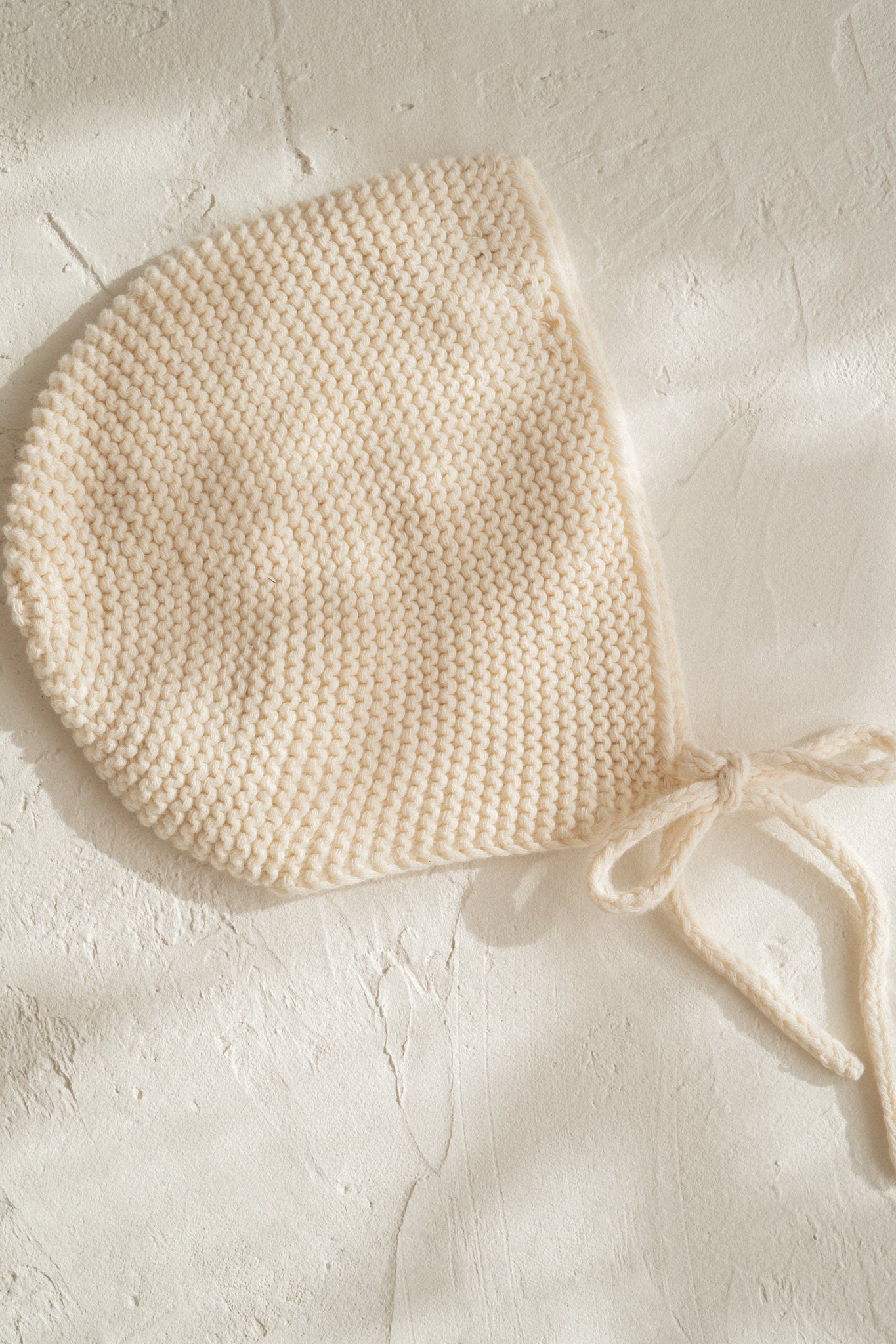 knitted cotton baby bonnet. Vanilla colour